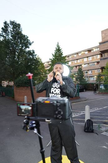 An artist performing straight to camera, with the camera rig in the foreground